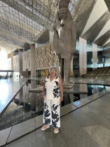 Ms. Mona Radwan (GRC's President) in front of King Ramses II statue at the GEM